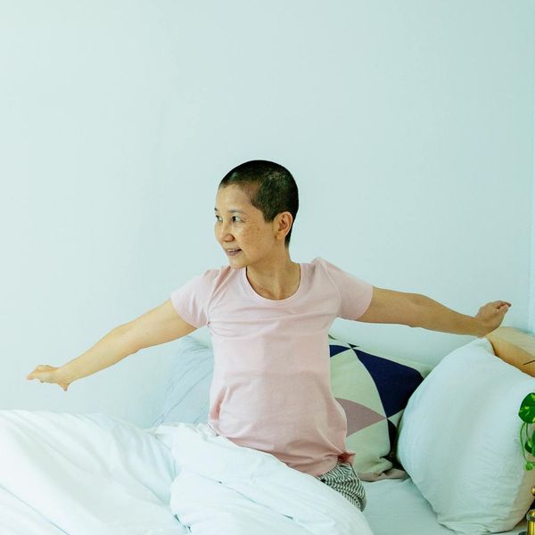 Energetic person stretching in a bright, modern space.